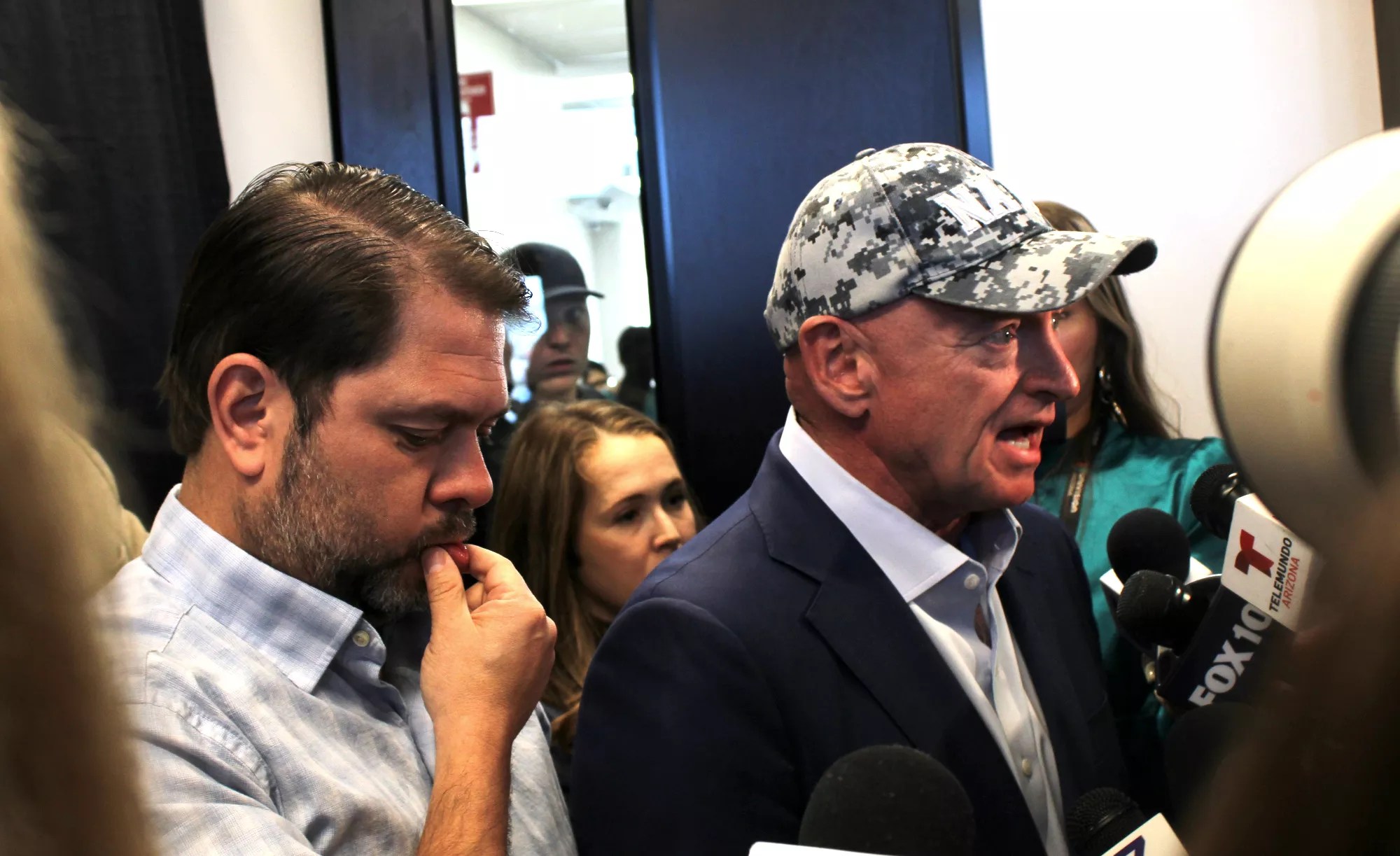 ruben gallego and mark kelly speak to a gaggle of reporters