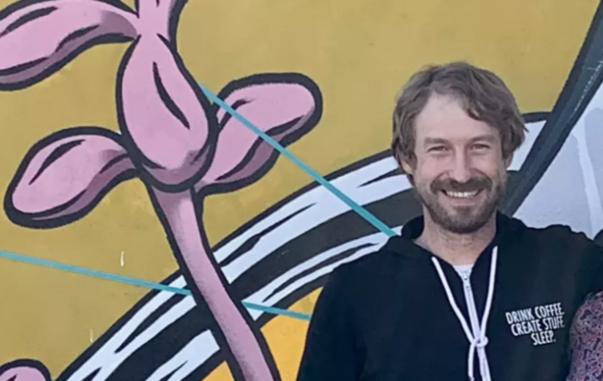 a man in a black zip-up hoodie