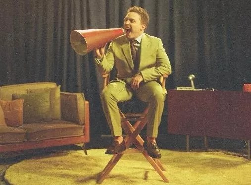 A man sitting in a director's chair.