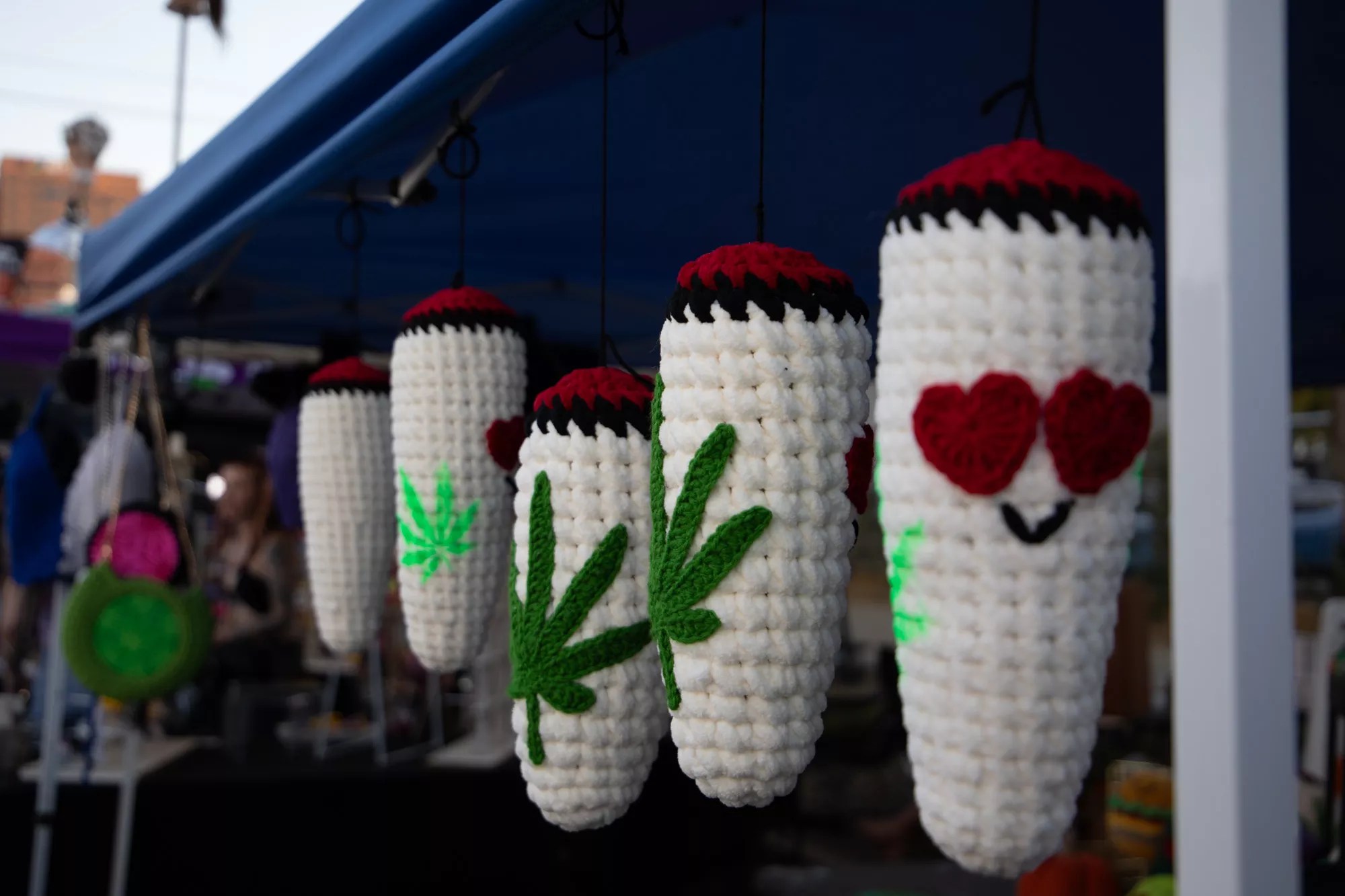 woven blunt ornaments hanging at a booth
