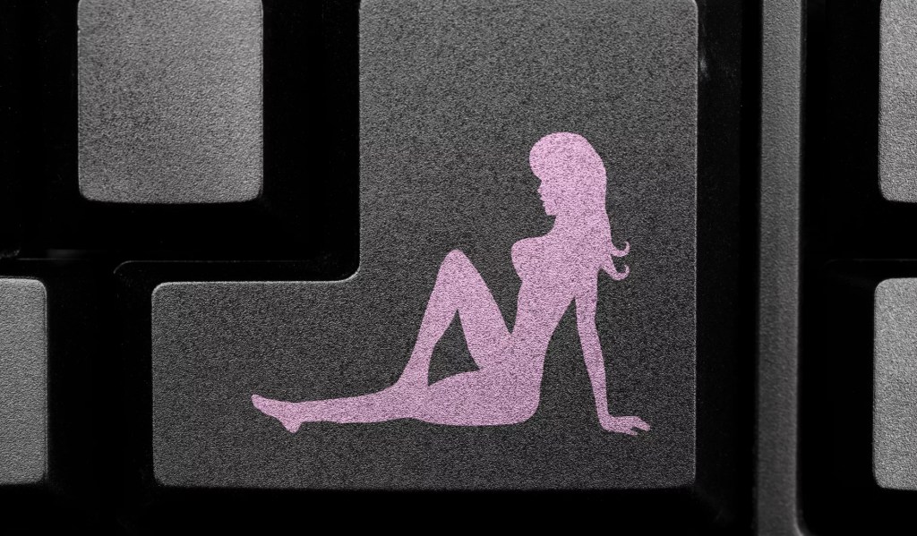 a silhouette of a naked woman on a computer keyboard