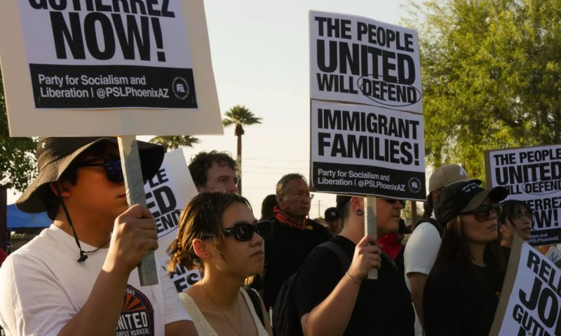 protesters hold signs