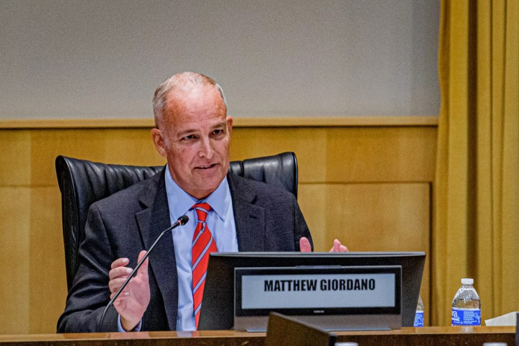 a man in a suit at a meeting