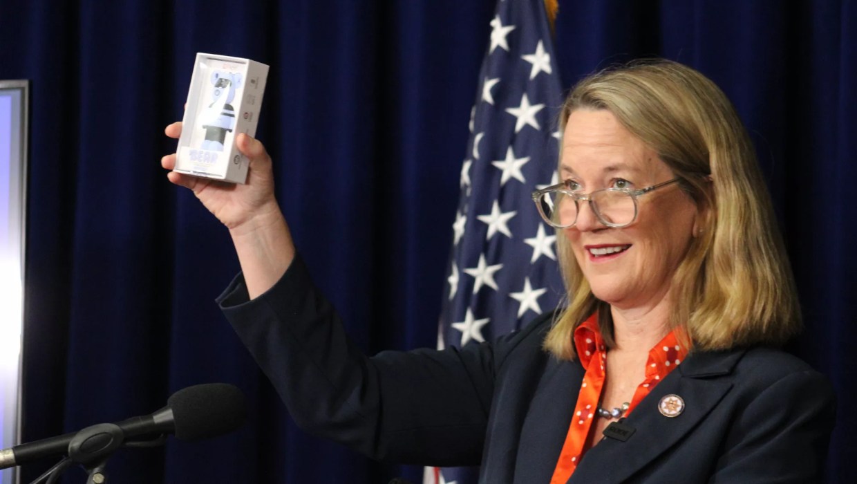 kris mayes holds up a vape cartridge at a press conference