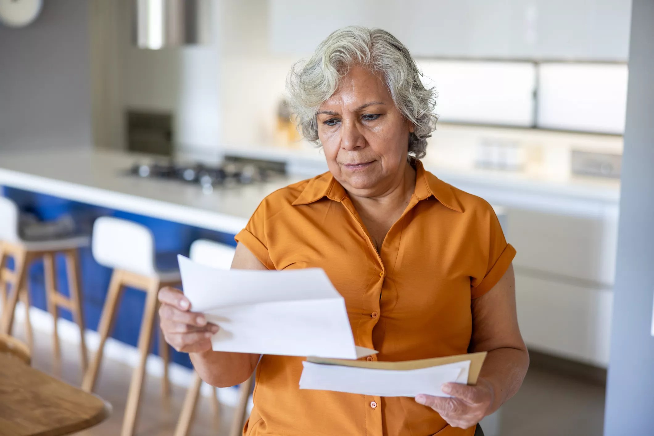 a woman reading a letter