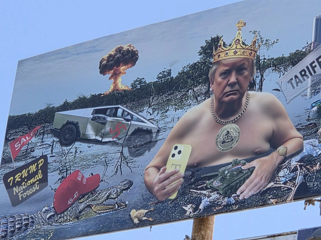 a close-up of a billboard showing donald trump shirtless wearing a crown in a swamp
