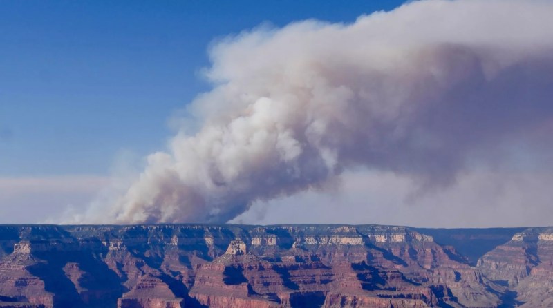 smoke billows above the grand canyon